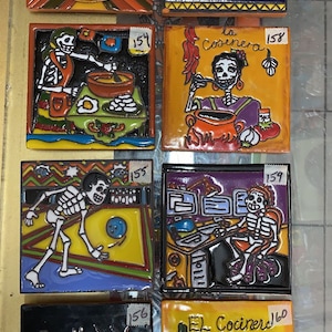 May include: Six colorful ceramic tiles with images of skeletons in various scenes. The tiles are numbered 153 through 160. The scenes include a skeleton playing bowling, a skeleton cooking, a skeleton at a computer, and a skeleton in a doctor's office. The tiles are decorated with bright colors and intricate details.