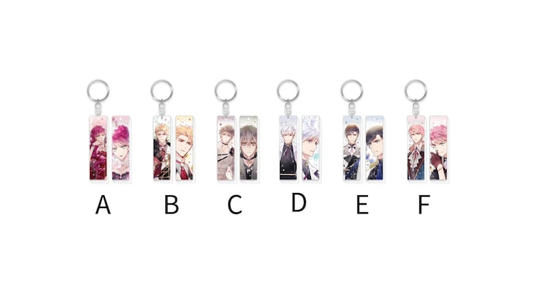 May include: Six different keychains with colorful anime characters on them. Each keychain has two characters on it. The keychains are labeled A through F.