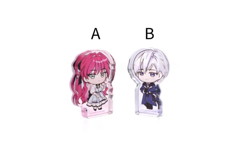 May include: Two acrylic anime character figures. One figure has pink hair and a white dress, the other has white hair and a dark blue outfit. Both figures are in a chibi style.