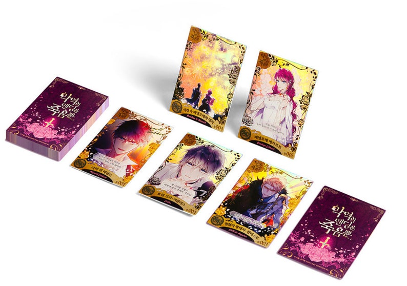 May include: A set of 7 collectible cards featuring characters from the graphic novel "The Holy Circle of the Sword". The cards are gold and purple with holographic accents. The cards feature different characters from the novel, including a woman in a white dress, a man with purple hair, and a man with black hair.