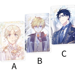 Puede incluir: Tres soportes acr&iacute;licos transparentes con ilustraciones de personajes de estilo anime. Los soportes muestran tres personajes diferentes, cada uno con peinados y atuendos &uacute;nicos. Los personajes est&aacute;n etiquetados A, B y C. Los soportes tienen un borde decorativo.