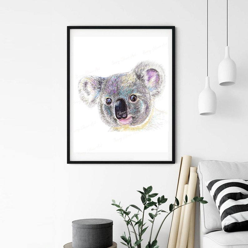 May include: A black and white drawing of a koala's face. The koala has a soft, fluffy appearance with a gentle expression. The drawing is framed in a black frame.