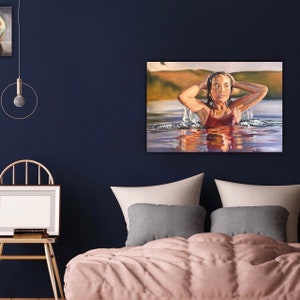 May include: A painting of a person with their arms raised above their head, emerging from a body of water. The person is wearing a red swimsuit and has long brown hair. The water is a light blue color and there are ripples on the surface. The background is a blurry landscape of green hills and a blue sky.