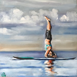 May include: A painting of a person doing a handstand on a paddleboard in the water. The sky is cloudy and the water is a light blue.