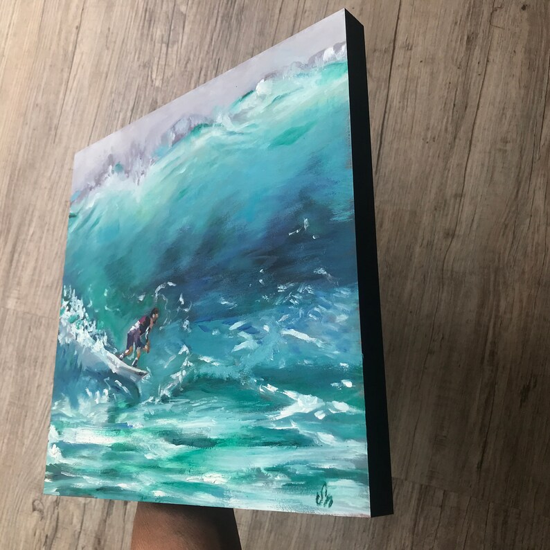 May include: A painting of a surfer riding a large wave. The wave is a vibrant blue-green color, and the surfer is wearing a red and black wetsuit. The painting is done in a realistic style and captures the energy and excitement of surfing.