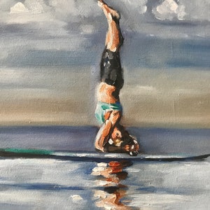 May include: A person does a handstand on a surfboard in the water. The sky is cloudy and the water is a light blue.