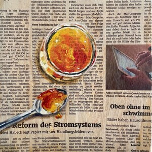 May include: A newspaper article with the headline "Reform of the Power System" and a photo of a spoon with a red and orange liquid inside. The text discusses the challenges facing Intel and Apple in the tech industry.