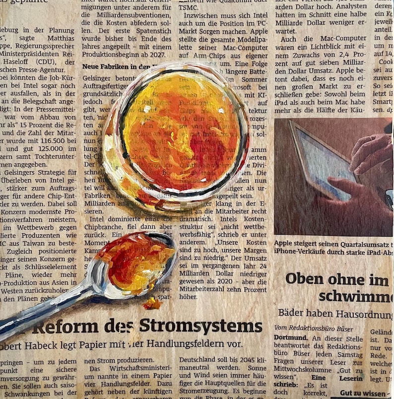 May include: A newspaper article with the headline "Reform of the Power System" and a photo of a spoon with a red and orange liquid inside. The text discusses the challenges facing Intel and Apple in the tech industry.