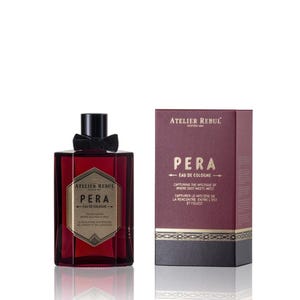 May include: A dark red glass bottle of Atelier Rebul Pera Eau de Cologne. The bottle has a black bow and a gold label with the brand name and product name. The bottle is sitting on a white surface. The box is dark red with gold accents and the text "Atelier Rebul Pera Eau de Cologne Capturing the mystique of where East meets West Capturer le mystère de la rencontre entre l'Est et l'Ouest"