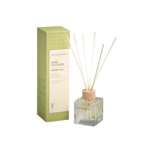 May include: A green tea reed diffuser with a clear glass bottle and wooden sticks. The bottle has a label that says "Atelier Rebul Reed Diffuser Green Tea".