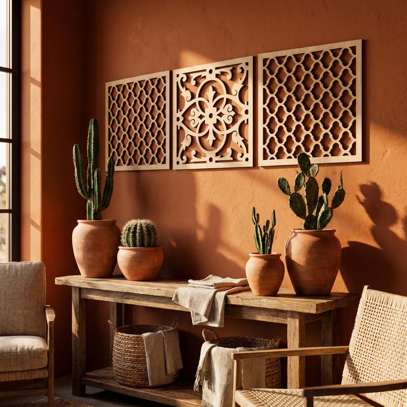 May include: A warm-toned interior scene featuring a wooden console table with terracotta pots holding cacti. Three decorative wooden panels with intricate cut-out designs hang on the wall above. Woven baskets and chairs complete the decor.