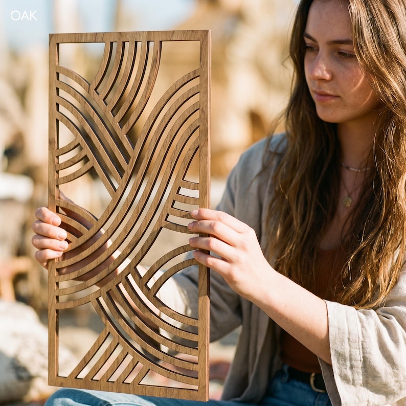 May include: A rectangular wooden wall art piece with a repeating wave pattern. The art is made of light brown wood and has a geometric design. The word "OAK" is in the upper left corner.