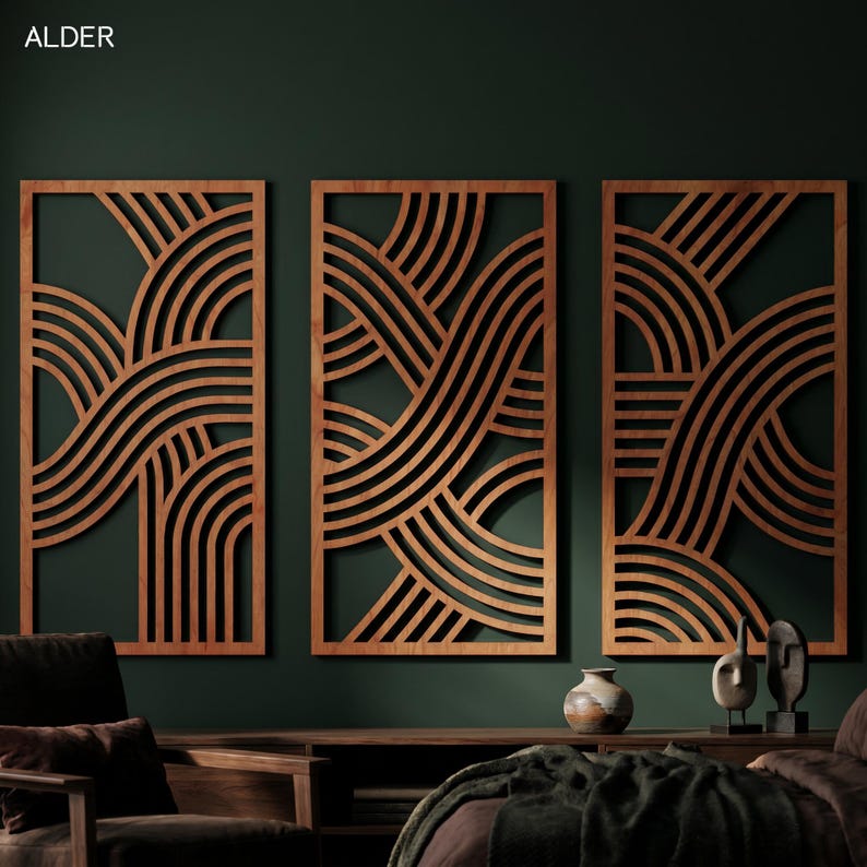 May include: Three wooden wall panels with a geometric design of curved lines. The panels are framed in a light brown color, with a dark brown design. The panels are mounted on a dark green wall.