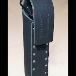 May include: A black leather case with a flap closure and a snap button. The case has a belt loop and a metal rivet design.
