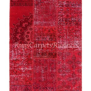 May include: A red patchwork rug with a variety of patterns and designs. The rug is made of recycled materials and is perfect for adding a touch of color and texture to any room.