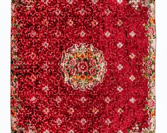 May include: A red rug with a floral pattern. The rug has a large, circular design in the center with smaller floral designs around the border.