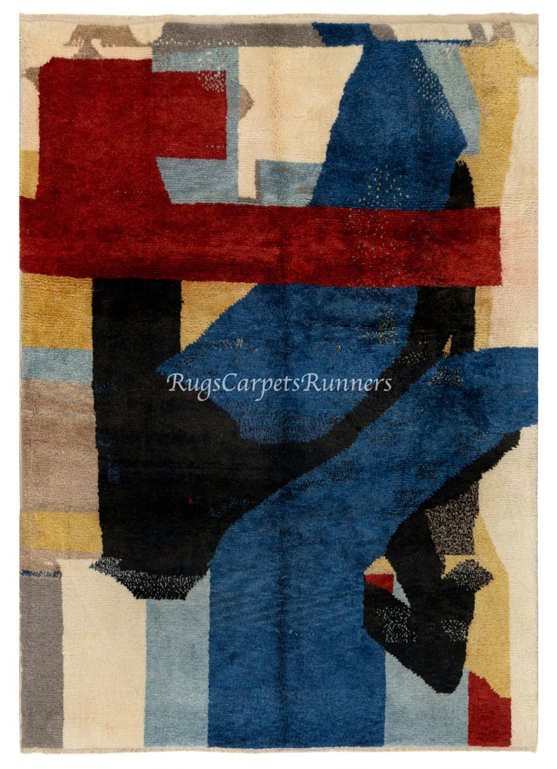 May include: Abstract area rug with geometric shapes in shades of red, blue, black, beige, and gray. The rug has a modern design and is perfect for adding a touch of color and style to any room.
