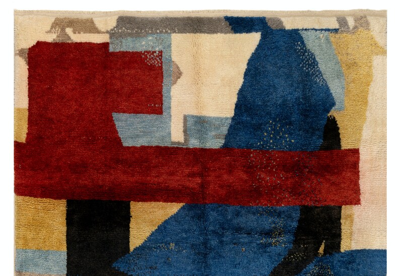 May include: Abstract geometric rug with a red, blue, beige, and black color scheme. The rug has a modern design with a variety of shapes and sizes.