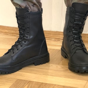 May include: A pair of black leather lace-up boots with thick soles.