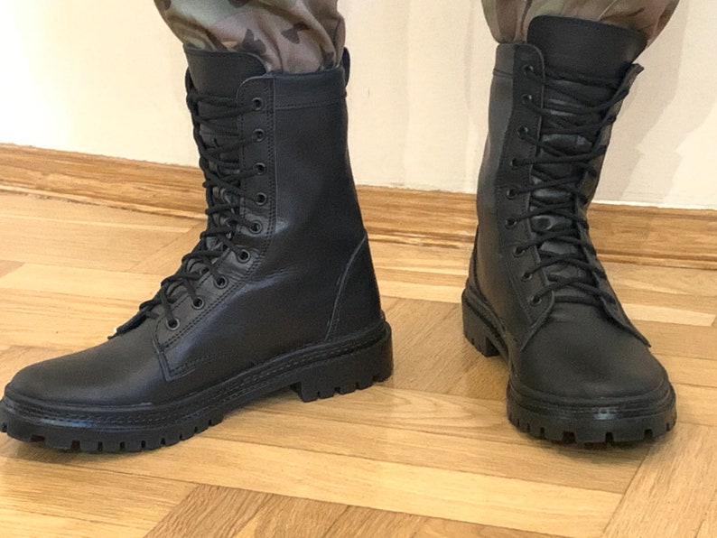 May include: A pair of black leather lace-up boots with thick soles.