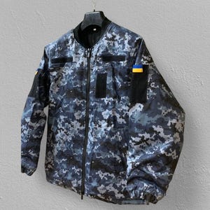 Blue pixel outdoor jacket – side view – Greta fabric – windproof design