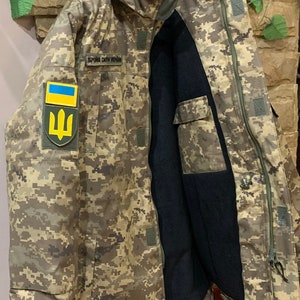 Inside view of the Ukrainian Pixel MM-14 jacket with the zipper open, showing inner lining and insulation.