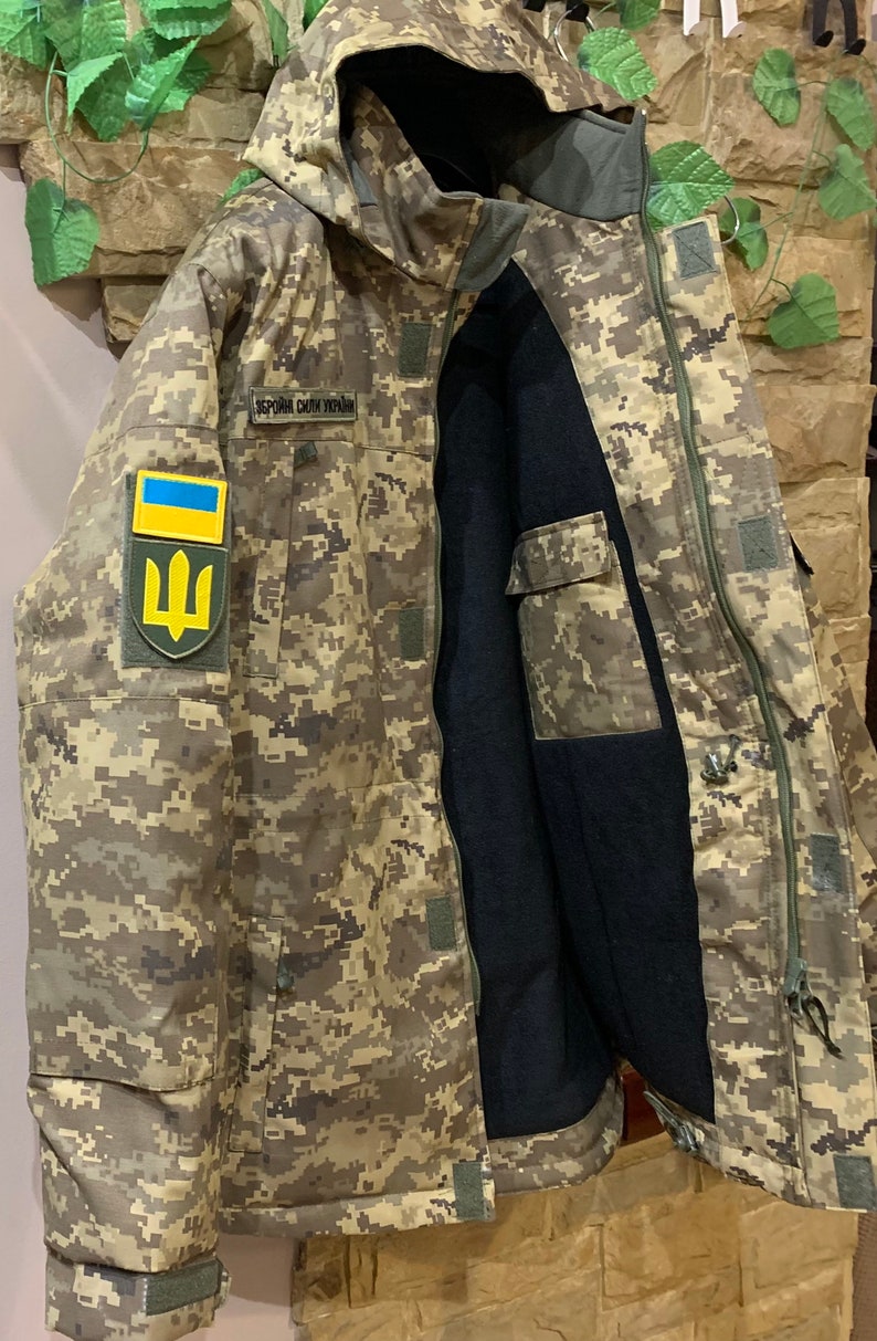 Inside view of the Ukrainian Pixel MM-14 jacket with the zipper open, showing inner lining and insulation.