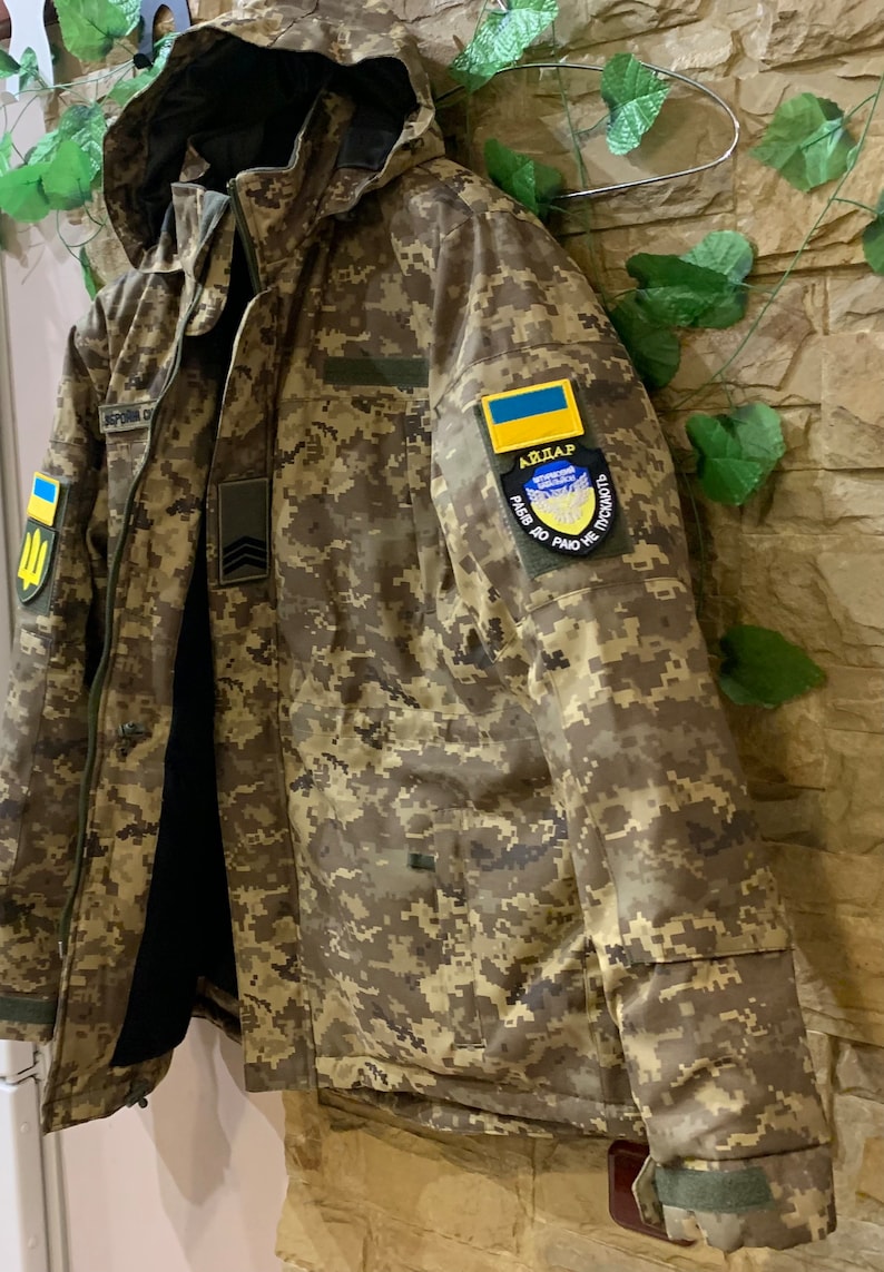 Left side view of Ukrainian Pixel MM-14 winter jacket, showing sleeve pocket, velcro panel and stitching details.
