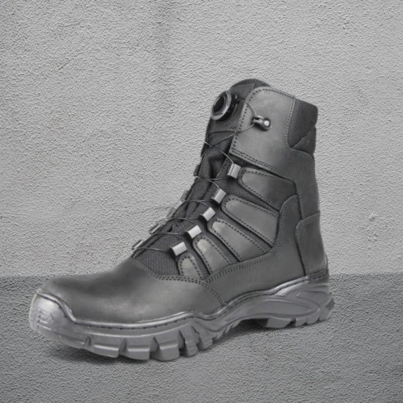 May include: Black tactical boot with a high-top design. The boot features a rugged sole, a lace-up closure system, and reinforced panels. The boot is made of durable materials and is suitable for outdoor activities. The boot is approximately 8 inches tall.