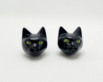 Green eyed black cats license plate screws