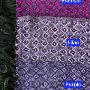 May include: Three fabric swatches with a diamond pattern. The top swatch is fuchsia, the middle swatch is lilac, and the bottom swatch is purple.