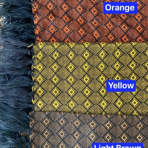 May include: Three fabric swatches with a diamond pattern. The top swatch is orange, the middle swatch is yellow, and the bottom swatch is light brown.