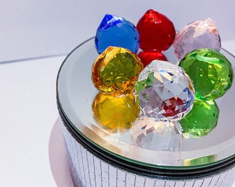 May include: A silver mirrored box with a lid containing six faceted crystal balls in various colors: red, blue, green, yellow, pink, and clear.