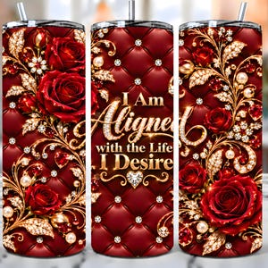 May include: A cylindrical tumbler featuring a deep red quilted pattern background with gold filigree, sparkling crystal accents, and red roses. The center displays the text "I Am Aligned with the Life I Desire" in gold lettering with a small heart icon.