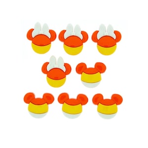 May include: Eight orange and yellow candy corn themed Mickey Mouse head shaped buttons with white bows.
