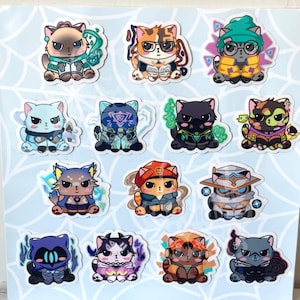 May include: A collection of colorful cat stickers with various designs. Each sticker features a cartoon cat dressed in different outfits, including futuristic armor, hats, and jackets. The stickers are arranged on a light blue background with a spiderweb pattern.