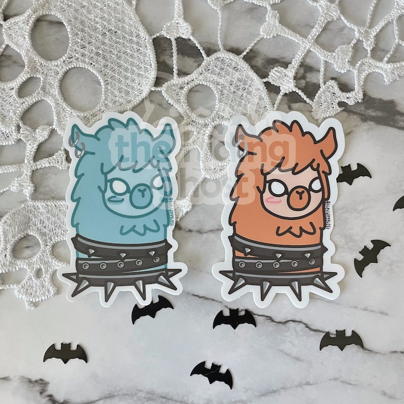 May include: Two cartoon llama stickers with a punk rock theme. The llamas are wearing studded collars and have spiky collars. One llama is blue and the other is orange.