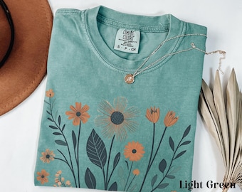 Camiseta con estampado de flores silvestres estilo bohemio, colores suaves y cómodos, camiseta vintage con flores, camiseta botánica, estampado floral vintage, camisetas con flores naturales, estilo cottagecore