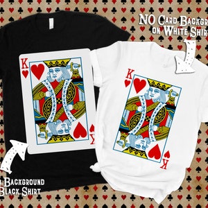 May include: A black t-shirt and a white t-shirt, each featuring a large graphic of a King of Hearts playing card. The black shirt includes a white rectangular card background behind the graphic, while the white shirt displays the card design directly.