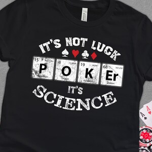May include: Black t-shirt with a white graphic design that says "It's not luck, it's science" with a poker theme. The graphic features the chemical symbols for the elements phosphorus, oxygen, potassium, and erbium, along with playing card suits.