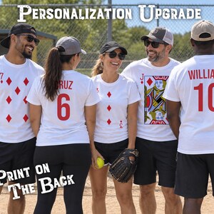 May include: Five white t-shirts featuring custom playing card designs and sports jersey-style lettering. The shirts display red diamond suits, numbers, a Jack of Diamonds graphic, and names like Cruz and Williams printed in red on the back.