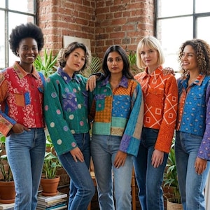 May include: Five individuals wearing long-sleeved, button-up quilted jackets in various vibrant colors and patterns, including red, teal, orange, and blue, paired with blue denim jeans. The jackets feature collars, front pockets, and stitching.