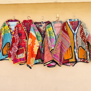 May include: Five long-sleeved jackets made from quilted fabric with various colourful patterns, including floral, paisley, and geometric prints. Each jacket features a V-neckline, open front, and two front pockets with contrasting trim.