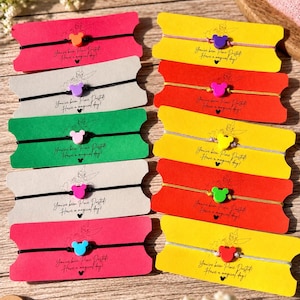 May include: Ten bracelets on individual rectangular cards with notched sides. Each bracelet features a small mouse-shaped charm in various colors including orange, purple, pink, yellow, green, blue, and red, attached to thin black or metallic cords.