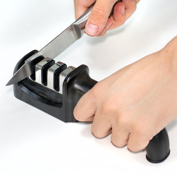 Premium Photo  Knife sharpener and a hand with a blade a man sharpens a  knife on a grinder