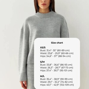 May include: Size chart for a sweater with measurements in inches and centimeters. XS/S: Bust 31.4"-35" (80-89 cm), Waist 23.6"-25.9" (60-66 cm), Hips 34.6"-37" (88-94 cm). S/M: Bust 33.8"-36.6" (86-93 cm), Waist 26.3"-28.7" (67-73 cm), Hips 37.4"-39.7" (95-101 cm). M/L: Bust 35.4"-38.9" (90-99 cm), Waist 29.1"-32.2" (74-82 cm), Hips 40.1"-42.9" (102-109 cm).
