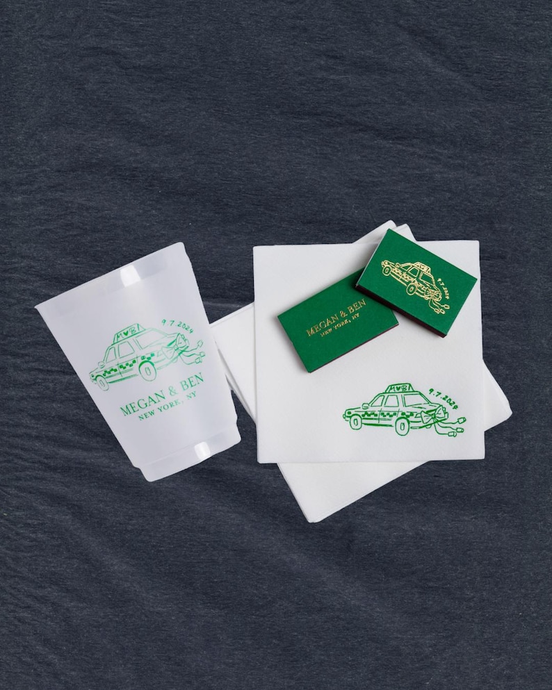 A collection of custom printed wedding favors featuring a green taxi design. Includes a frosted plastic cup, green matchboxes, and white cocktail linen textured napkins. The text within each of the designs and products is personalized  with "Megan & Ben, New York, NY" and the date "9.7.2024".