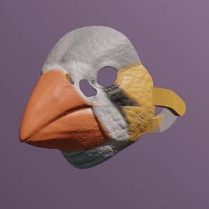 Könnte beinhalten: Eine weiße, orange und gelbe Vogelmaske mit einem Schnabel und Augenlöchern. Die Maske besteht aus einem strukturierten Material und hat einen 3D-Effekt.