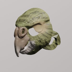 May include: A green, brown, and beige parrot mask with a beak and eye holes. The mask is made of a textured material and has a 3D effect.