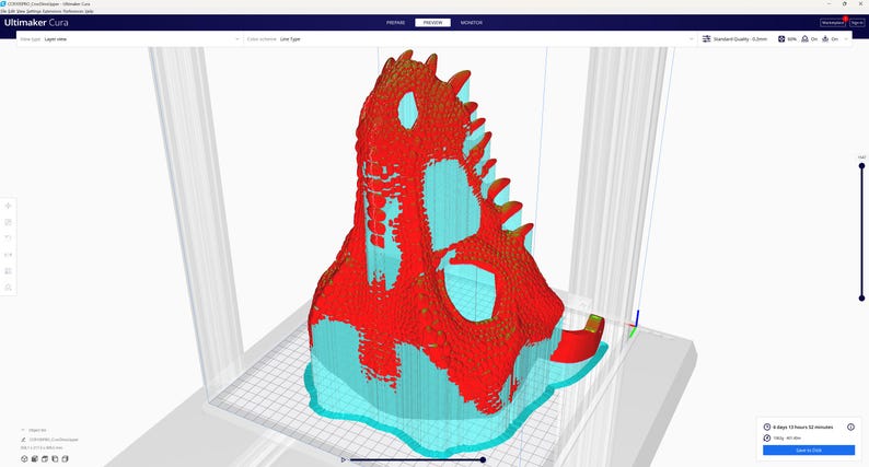 May include: A 3D model of a dinosaur skull, rendered in a 3D modeling program. The model is primarily red with turquoise and yellow accents. The image is a screenshot of the Ultimaker Cura software interface.
